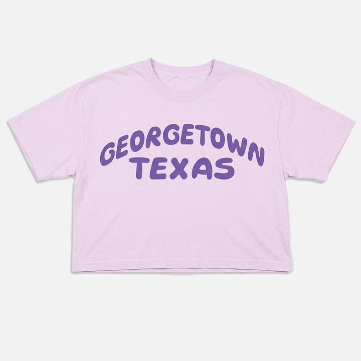 Orchid women’s boxy t-shirt with purple Georgetown Texas retro style graphic flat lay