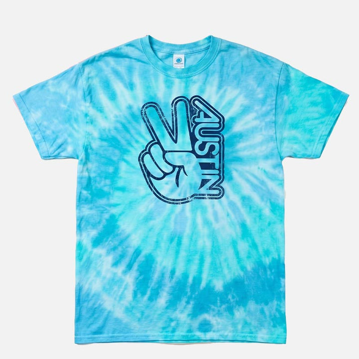 Groovy Austin tie-dye t-shirt in Blue Lagoon featuring a distressed navy Austin peace sign graphic on a blue, aqua, and white Colortone tie-dye unisex tee.
