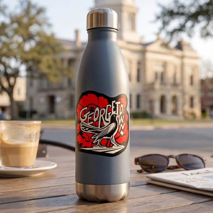 GTX Grackle Strut Georgetown vinyl sticker shown as a close-up product image and applied to a stainless steel water bottle in an outdoor Georgetown, Texas lifestyle setting.