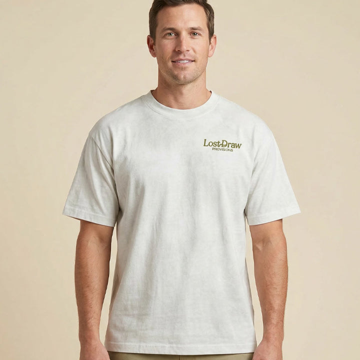 Model wearing GTX Ranger oversized boxy tee in dirty white with Lost Draw Provisions logo on front chest.