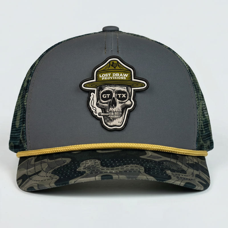 Front-facing view of the GTX Ranger Hat showing the skull ranger patch, dark gray structured front panel, gold rope detail, and topo camo bill.