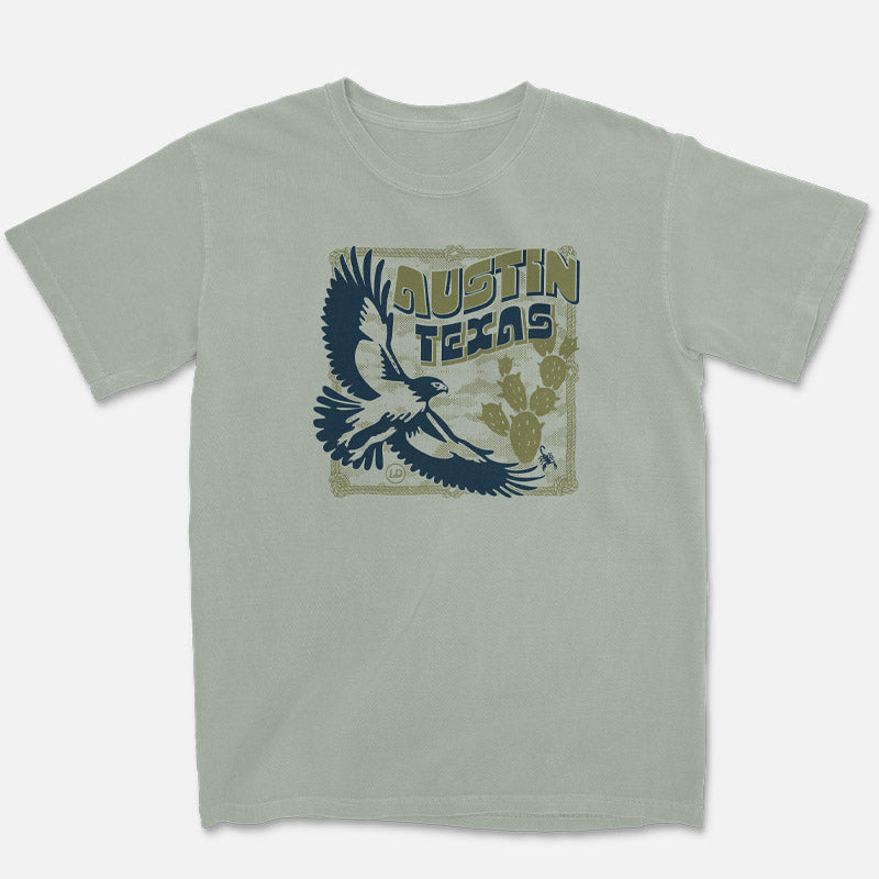 Hawk and Thorn Austin t-shirt with flying hawk and cactus graphic on bay green tee flat lay