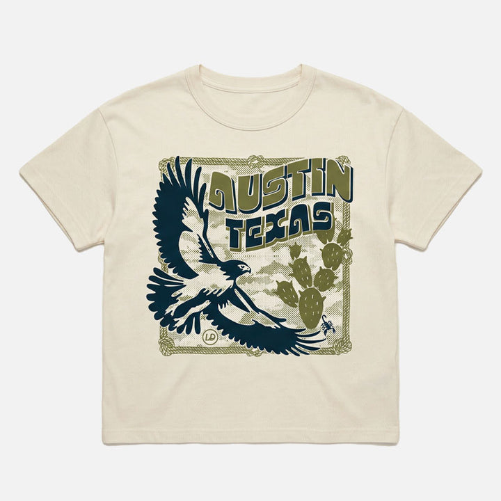Flat lay of Hawk & Thorn women’s graphic t-shirt on vintage white  tee