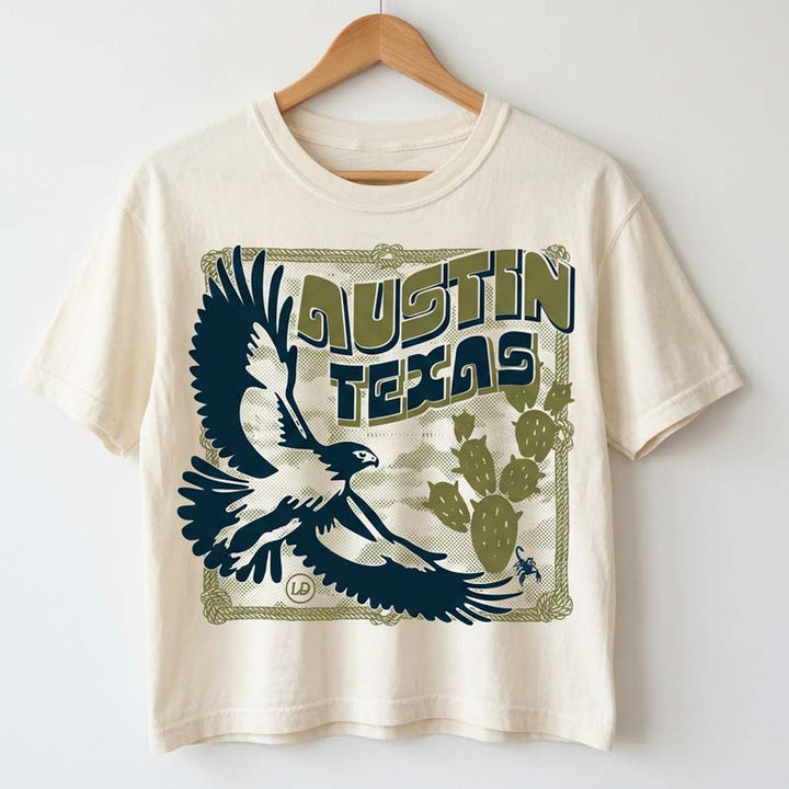 Hawk & Thorn women’s graphic t-shirt hanging on a hanger