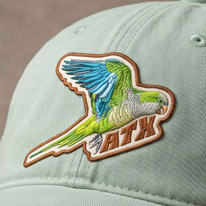 Close-up of Quaker Parrot ATX Hat patch detail and sunwashed cotton fabric texture