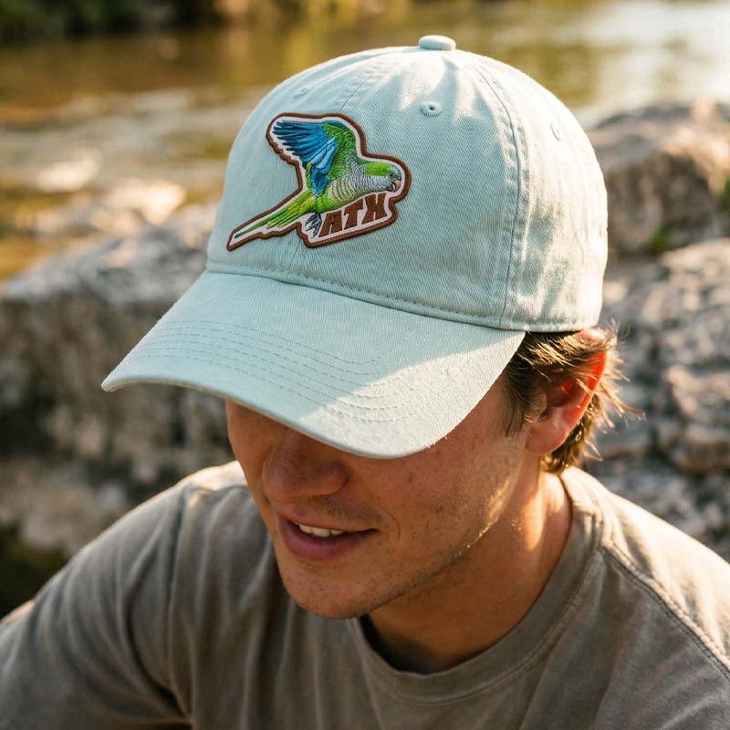 Person wearing Quaker Parrot ATX Hat outdoors in Austin Texas
