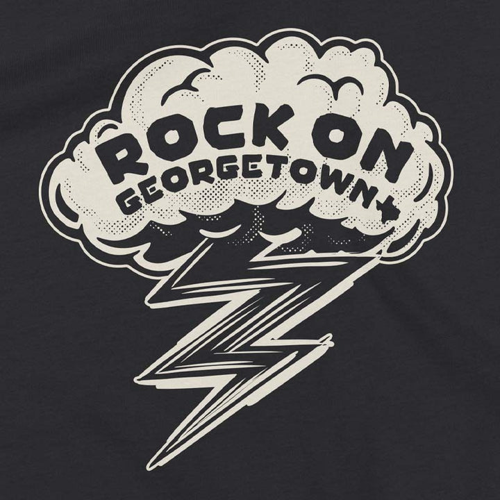Close-up of the Rock On Georgetown youth shirt graphic featuring bold lettering, lightning bolt artwork, and vintage distressed detailing on dark grey fabric.