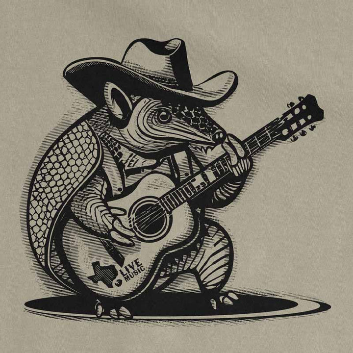Close-up of Rockin Armadillo graphic featuring a cowboy hat-wearing armadillo playing guitar on sandstone tee