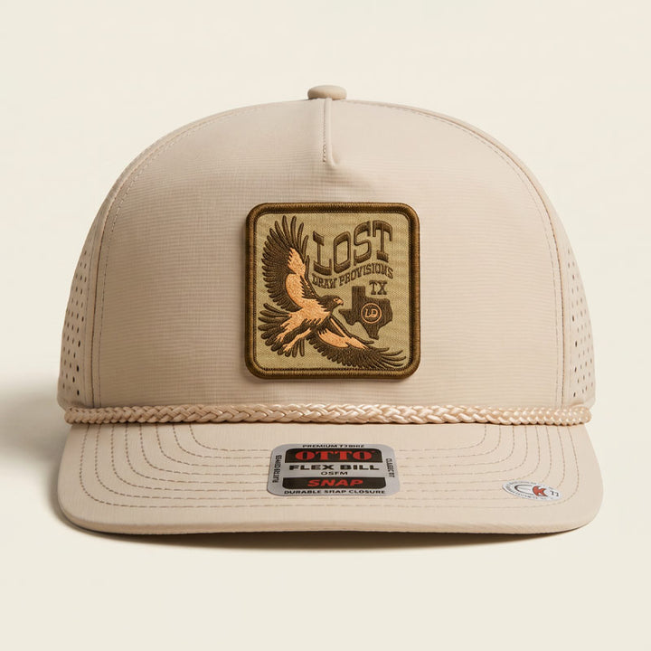 Lost Draw Provisions Lost Hawk khaki rope snapback hat featuring a detailed embroidered-style hawk patch on the front. Structured Otto 5-panel design with braided rope detail across the brim and adjustable snapback fit.