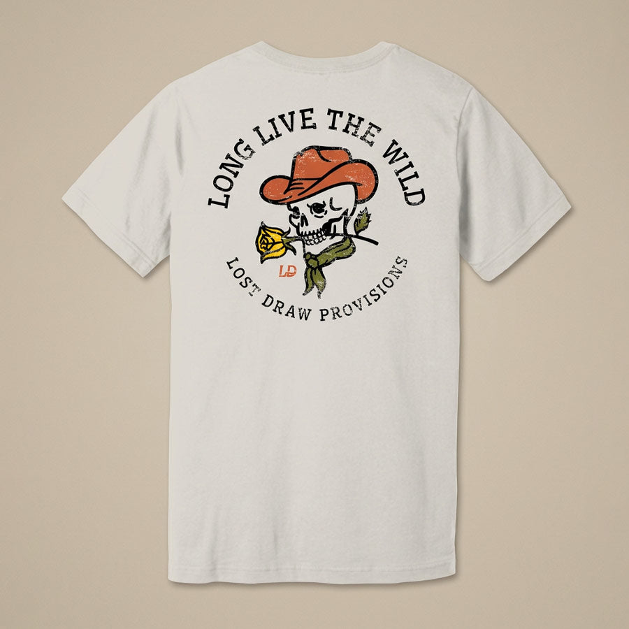 A white short-sleeve t-shirt shown from the back, featuring a graphic print of a skull wearing an orange cowboy hat and holding a yellow rose. The text &