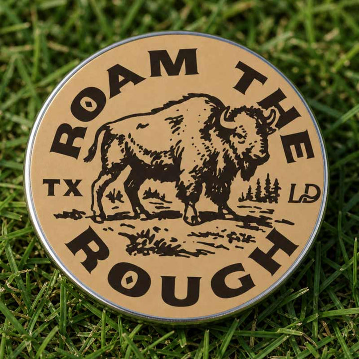 A round metal tin with a tan label featuring a black bison illustration and the text &