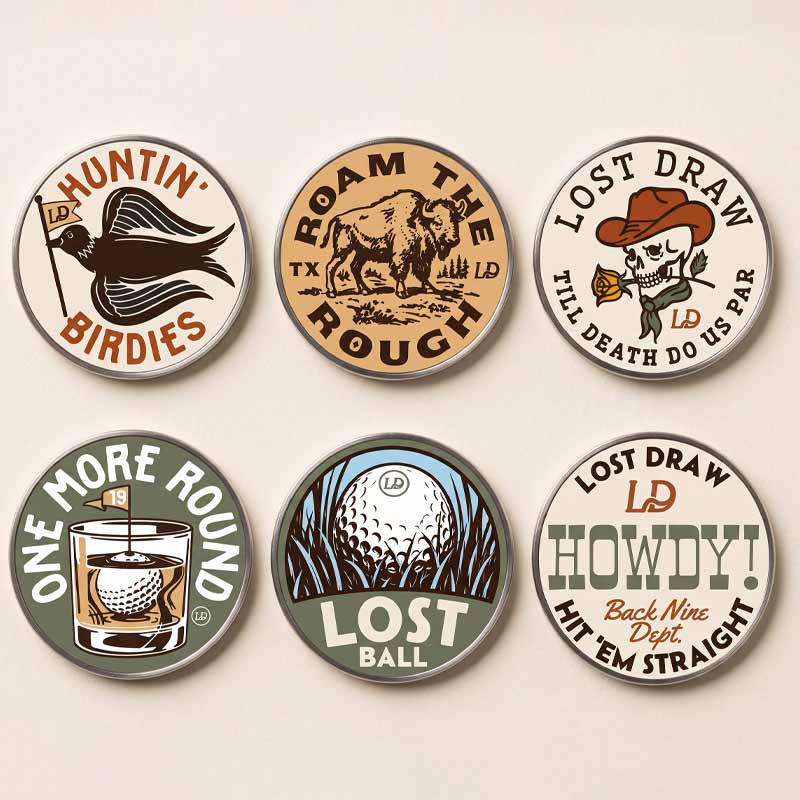 Six round metal golf-themed pinback buttons arranged in a 2x3 grid on a light beige background. The buttons feature vintage-style illustrations and text including &