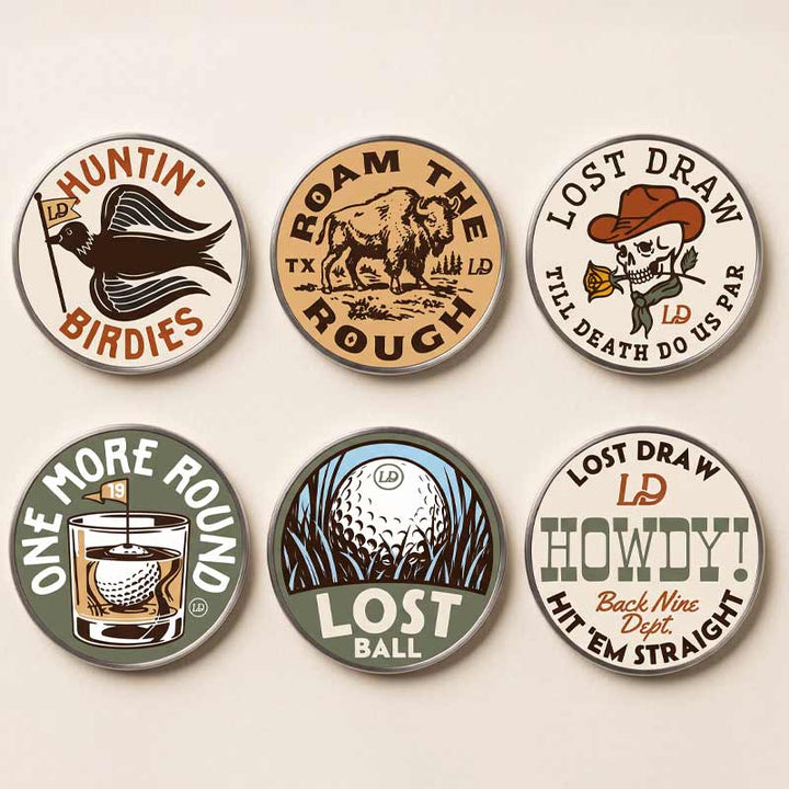 Six round metal golf-themed pinback buttons arranged in a 2x3 grid on a light beige background. The buttons feature vintage-style illustrations and text including &