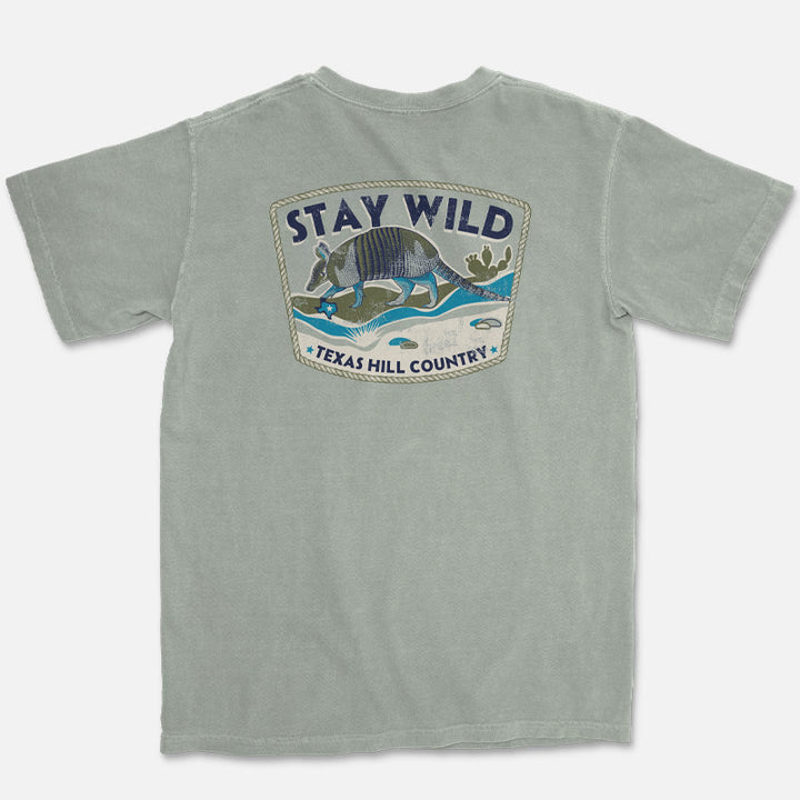 Stay Wild Texas Hill Country armadillo graphic printed on the back of a Comfort Colors 1717 Bay t-shirt
