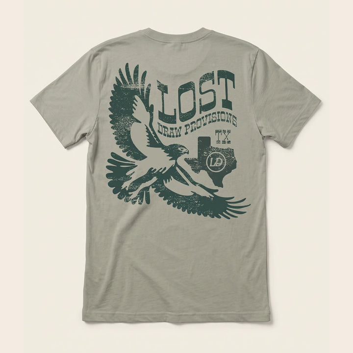 Back of the Lost Hawk Jersey Tee featuring distressed forest-green hawk illustrations, vintage Lost Draw Provisions lettering, and Texas artwork on a Thyme green shirt.