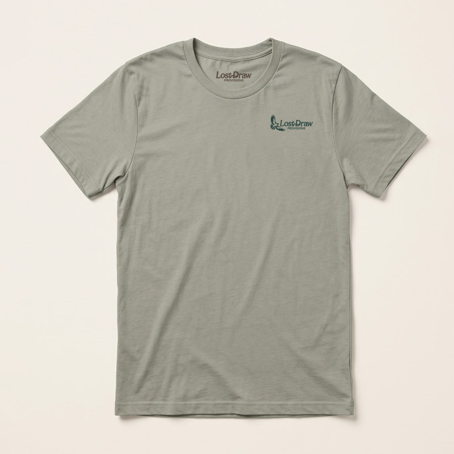 Lost Hawk Jersey Tee in Thyme green featuring a small forest-green Lost Draw Provisions hawk logo on the left chest.
