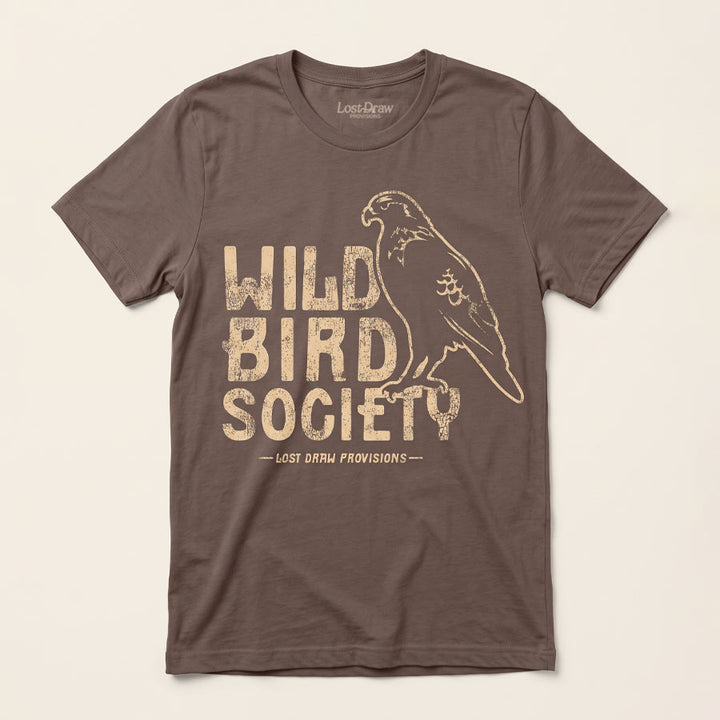 Front of the Wild Bird Society Jersey Tee in Cocoa featuring a distressed cream bird illustration and vintage lettering.